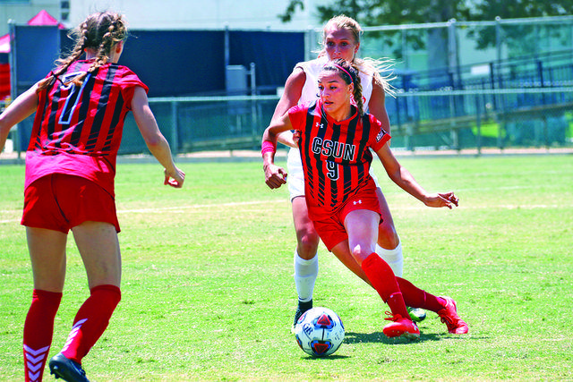 csun womens soccer players in red and black playing soccer