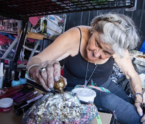Lynda Zazanis paints a lava rock with nail polish inside her tent on Aquaduct Avenue near the 405 and Nordhoff on Sep. 28
