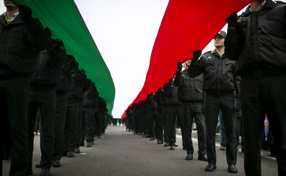 Iranian policemen hold a national flag of Iran during a rally marking the 38th anniversary of the victory of the Islamic revolution in 1979 on Feb. 10, 2017 in Tehran, Iran. (Ahmad Halabisaz/Xinhua/Zuma Press/TNS)