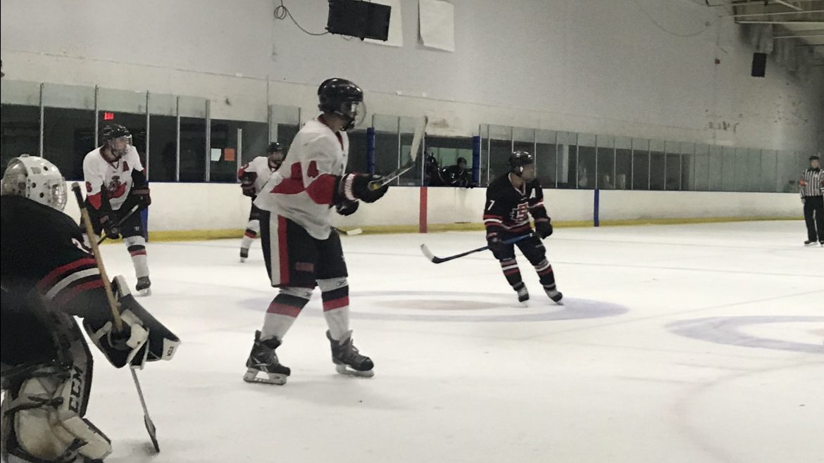 Andre Ramirez (4) and John Michael Laurin (6) position themselves to strike a possible loose puck Sunday afternoon at Simi Valley’s Iceoplex. Photo credit: Solomon Ladvienka