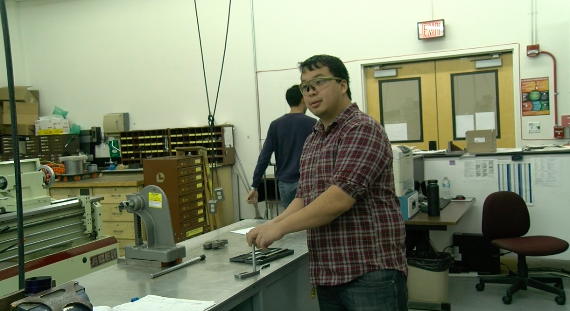 Mechanical engineering major Max Tchen in the Machine Shop wearing safety googles, everyone must wear while inside.