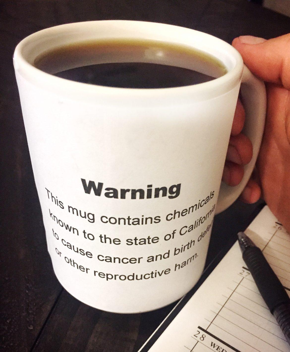coffee mug with warning sign on it