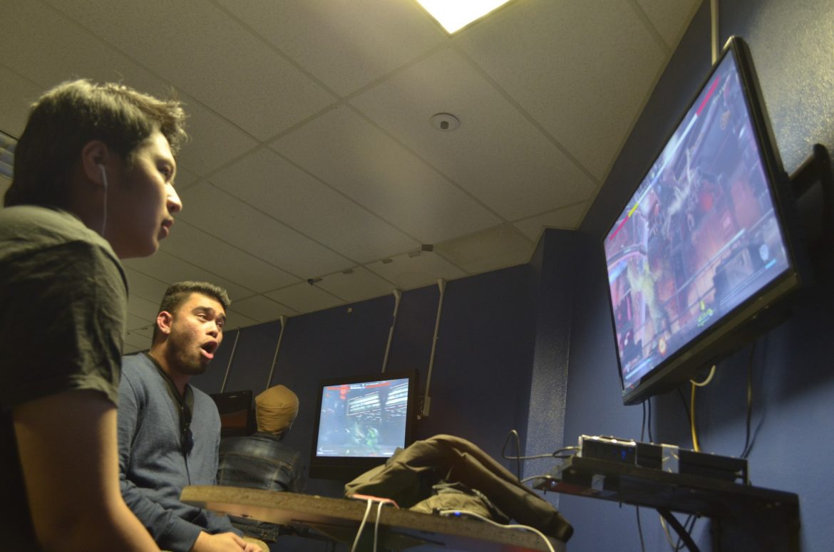 man shockingly watches video game screen