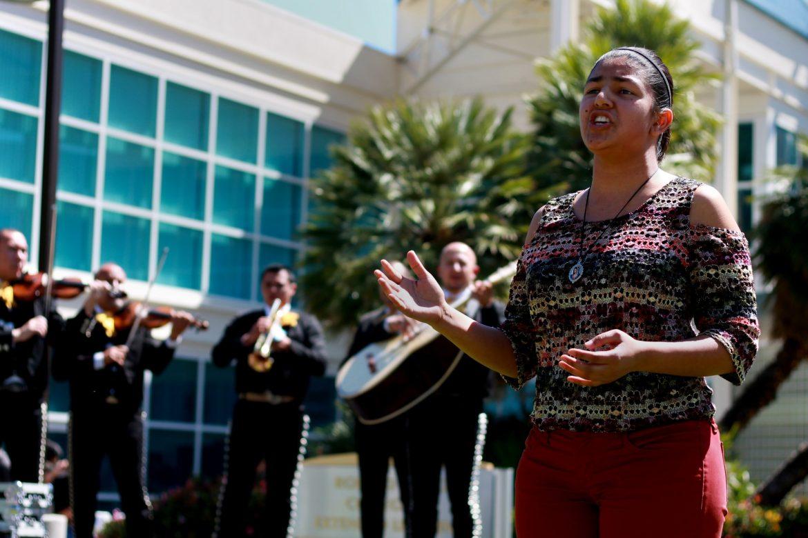 Adriana Covarrubias, 20 and a Child and Adolescent Development major, shares her voice in an impromptu performance with the mariachi band. Photo credit: Clare Calzada