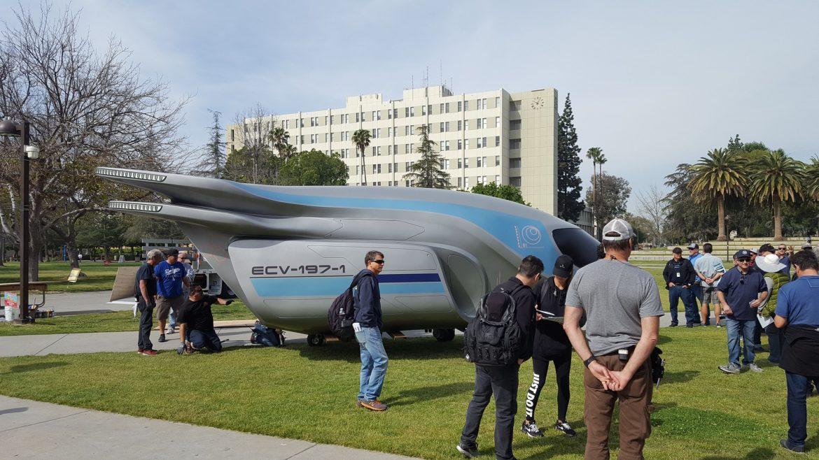 space ship on the oviatt lawn with many people surrounding it
