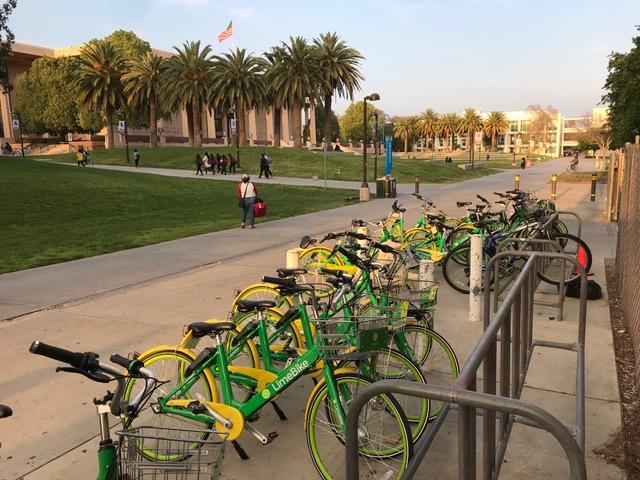 green and yellow lime bikes in bike rack