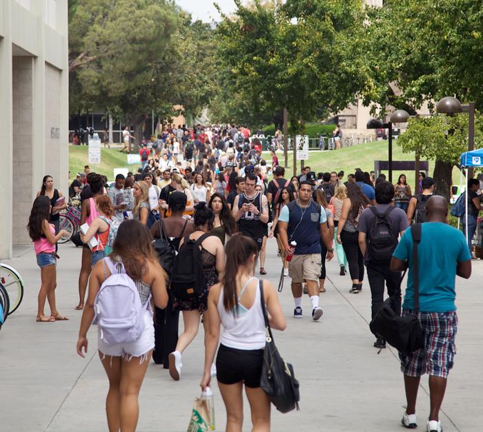 students busily walk on sidewalk