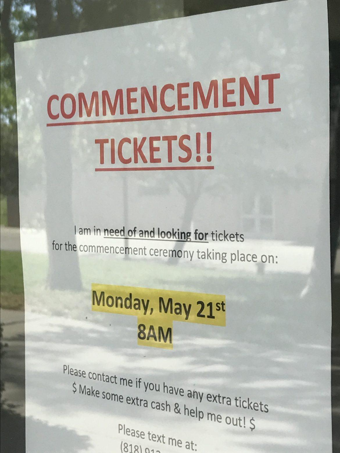 Posters like this one (outside Sierra Hall) litter the campus, as students desperately seek last minute graduation tickets. Photo credit: Tandy Lau