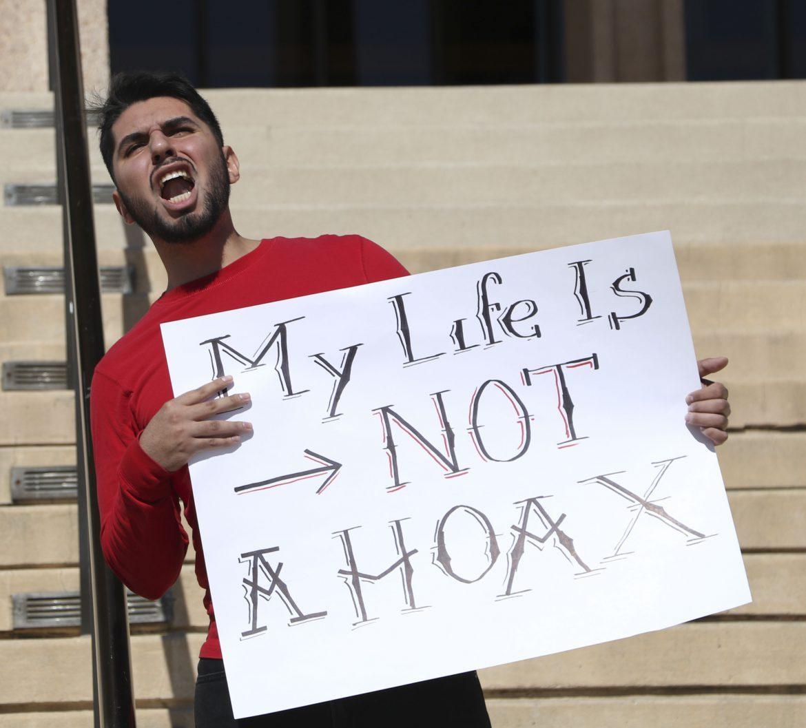 Daniel Gomez yells out a chant as he protests against the “Gun Hoax” and how the school police handled the situation in front of the Oviatt Library. Photo credit: Daniel Valencia