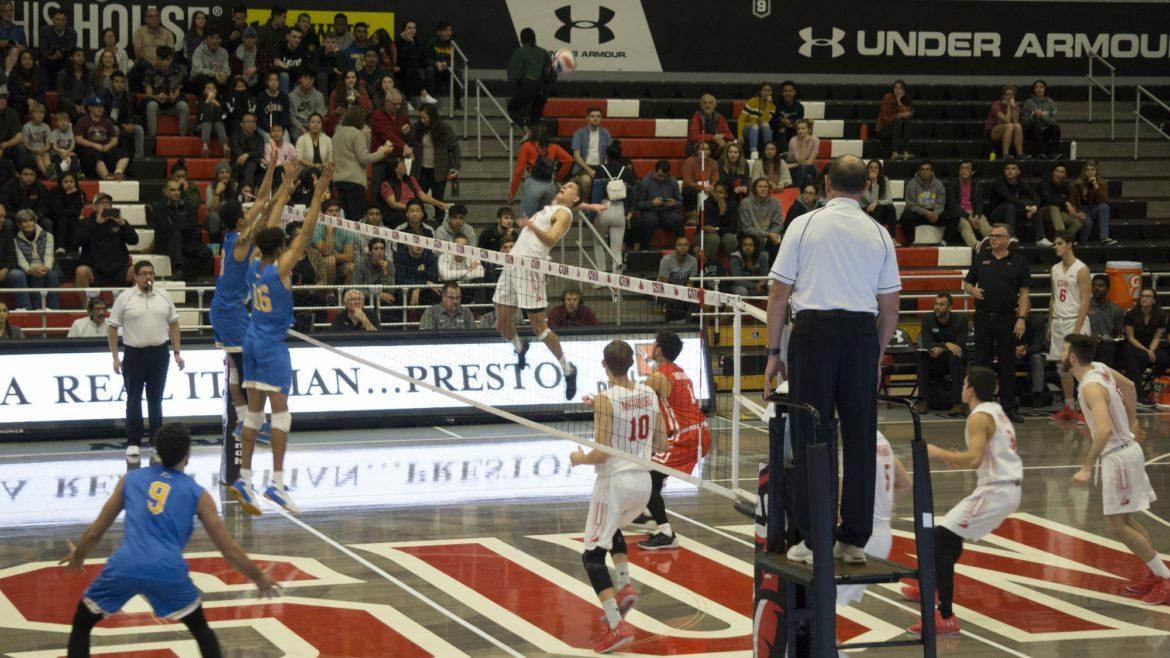 Two UCLA players attempt to block a CSUN spike in the Matadors' sweep over the Bruins on Wednesday night at the Matadome. The 12th-ranked Matadors beat the 2nd-ranked Bruins in CSUN's home opener and are now 3-1. Photo credit: Jairo Alvarado