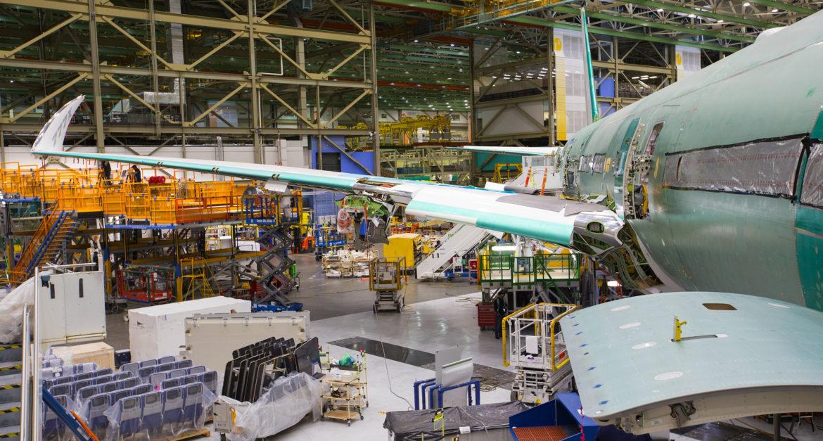 The wing of the new 777X, with the 11-ft wingtip folded up so it can fit inside the Everett assembly bay. It will similiarly be folded up to fit at airport gates. This airplane is the first 777X that will fly in 2019. (Mike Siegel/The Seattle Times/TNS)