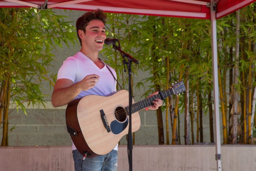 Matt Anspach, 20, performs an acoustic set during the USU Noontime Concert on Sept. 5. Photo credit: Serena Christie