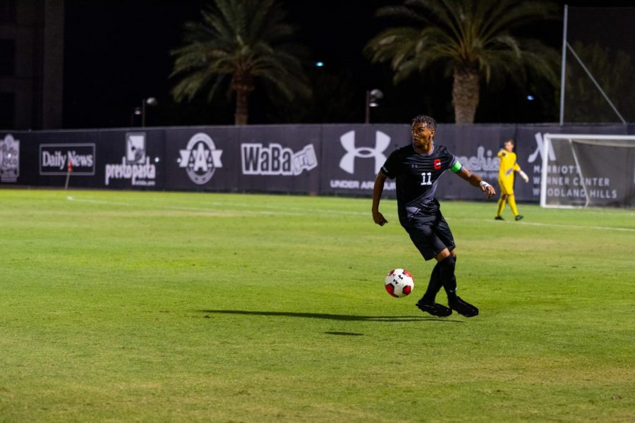 A CSUN Mens Soccer player at a ball possession