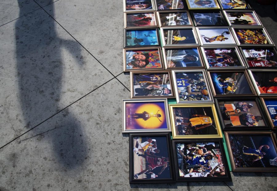 Fans lay out photographs of Kobe Bryant throughout his career outside The Staples Center days after he died in a helicopter crash.