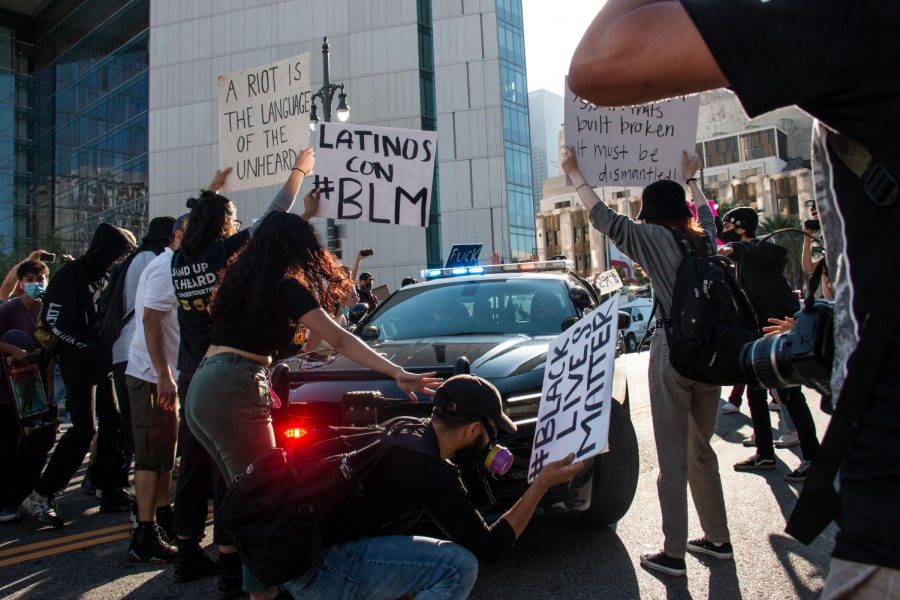 Protesters block a CHP vehicle as it drives past the LAPD headquarters on Thursday.