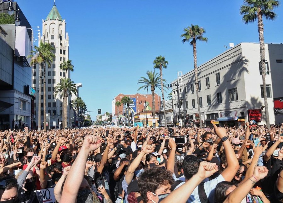 Protesters hold their fists up during the protest on Hollywood Boulevard.