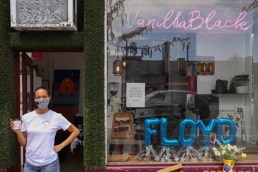 Vanessa Butler, the owner of VanillaBlack, stands at the entrance of the Echo Park coffee shop on Thursday, June 25, 2020. Butler said the coffee shop remained open throughout the pandemic with implemented safety precautions.