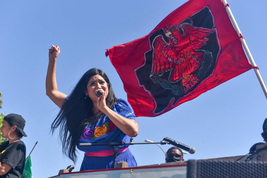Zada Musica, a Los Angeles artist, performs during rally for the 50th anniversary of the Chicano Moratorium on Saturday, Aug. 29, 2020 in East Los Angeles, Calif.