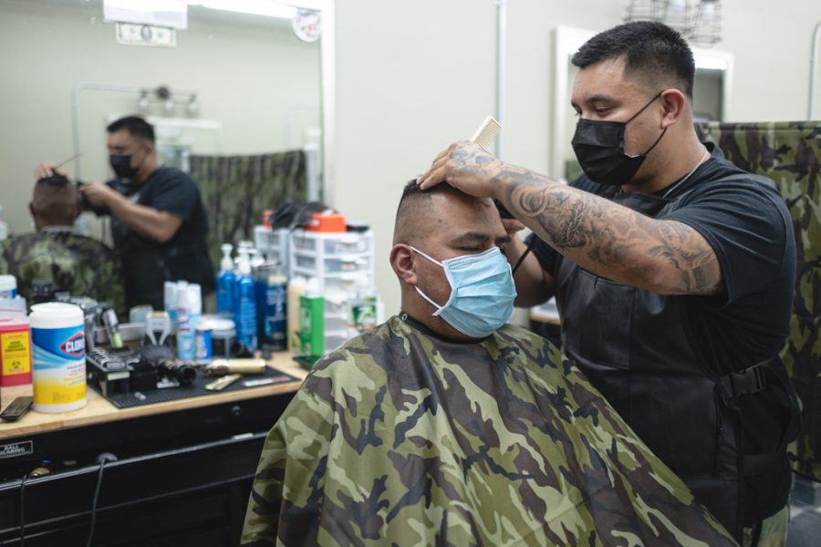 David Lopez, the owner of Modern Barber Room, cuts Jose Chavezs hair at his shop in Northridge, Calif., on Wednesday, Sept. 16, 2020.