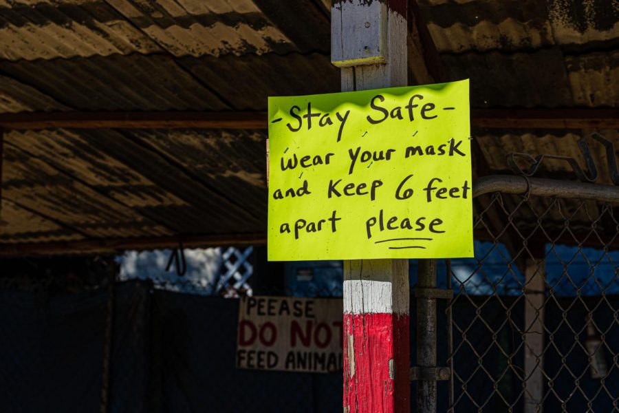 A sign reminding customers to socially distance and wear masks in front of the animal booth at Tapia Brothers Farm in Encino, Calif., on Thursday, Oct 29, 2020.