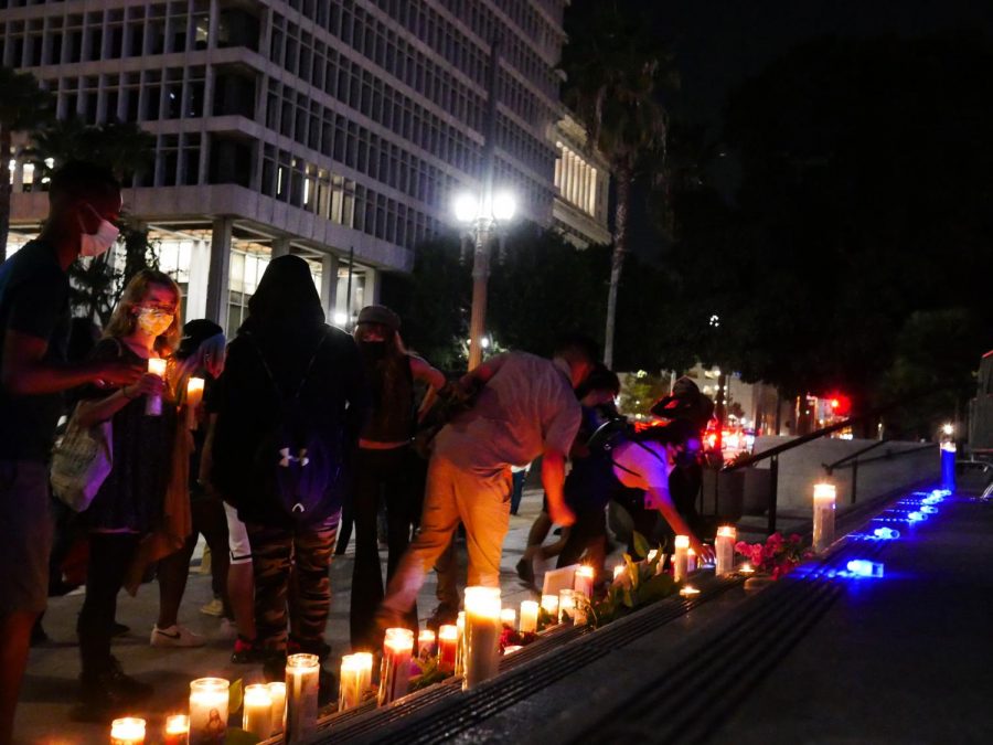 Mourners placing candles on the steps of Los Angeles City Hall in remembrance of George Floyd on his 47th birthday on Wednesday, Oct. 14, 2020.
