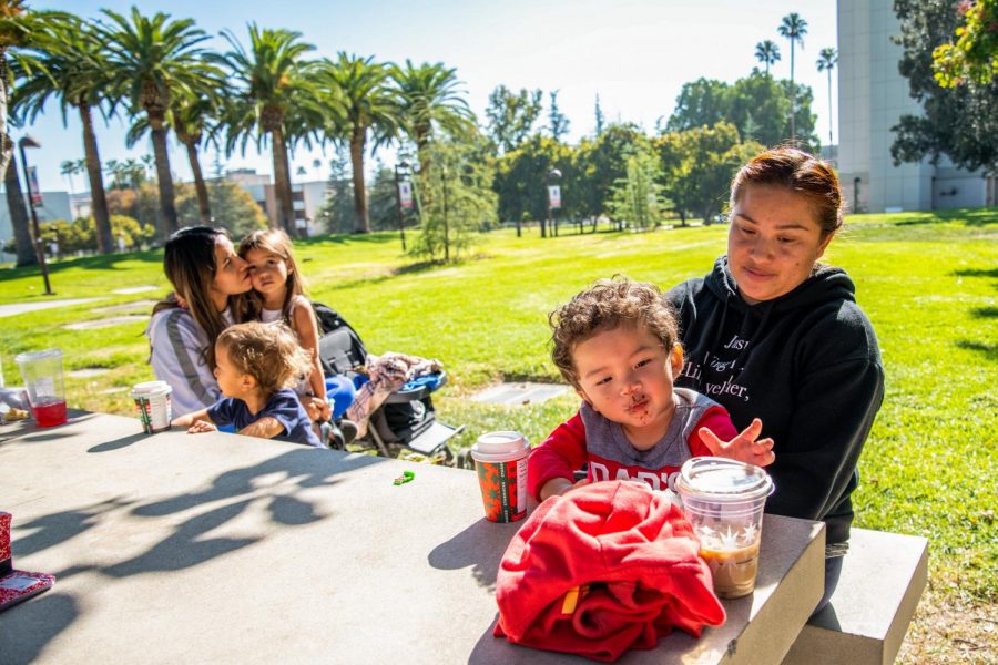 Kenia Ochoa, left, and her children, Bell and Sonny Brooks, spend time with Andrea Antonio, right, and her son, Luca DeLeon, at the CSUN campus on Nov. 13, 2020.
