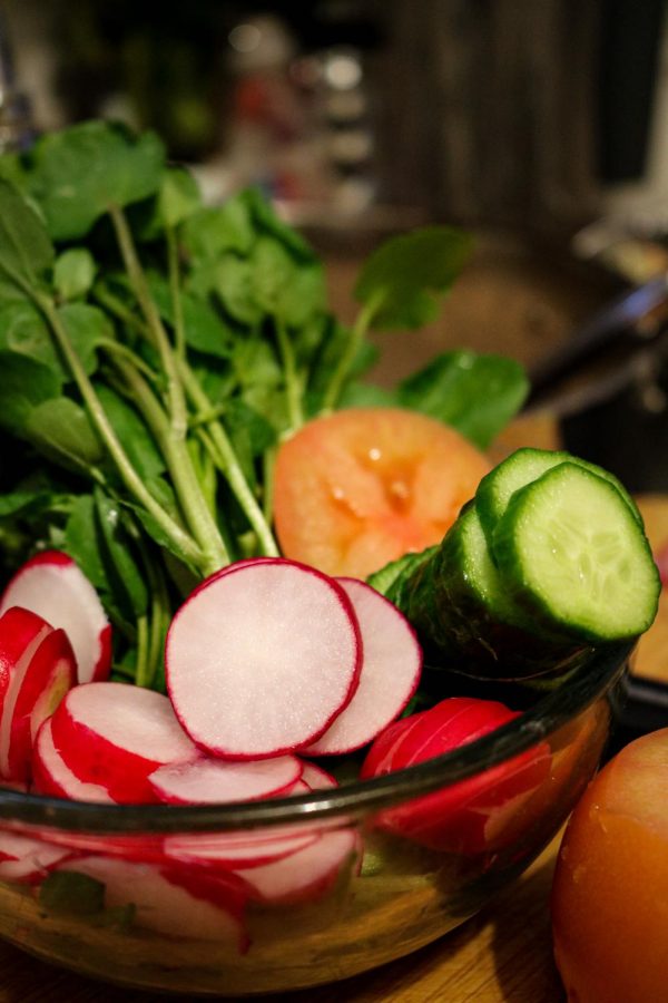Fresh vegetables that will be used to make a banh mi.