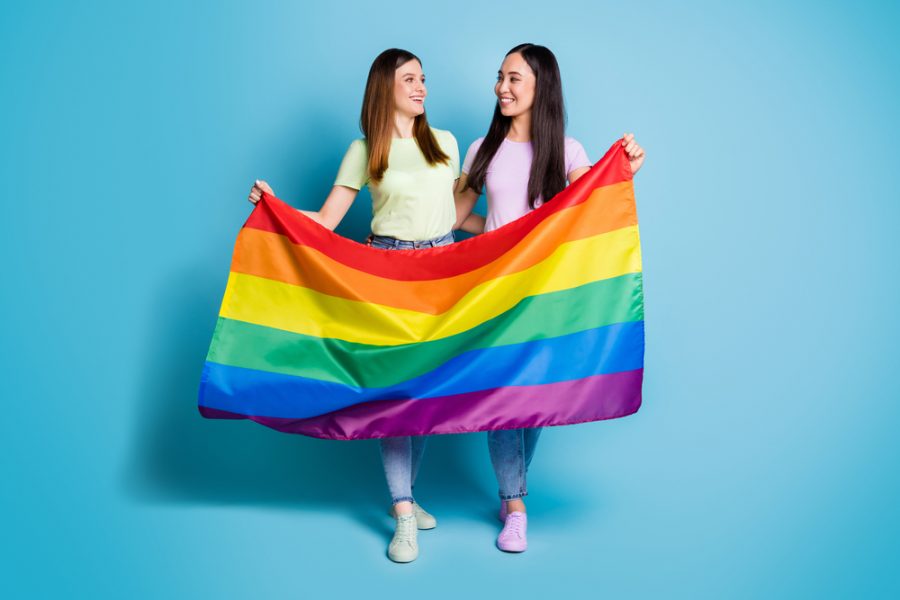 Two+womed+holding+rainbow+flag