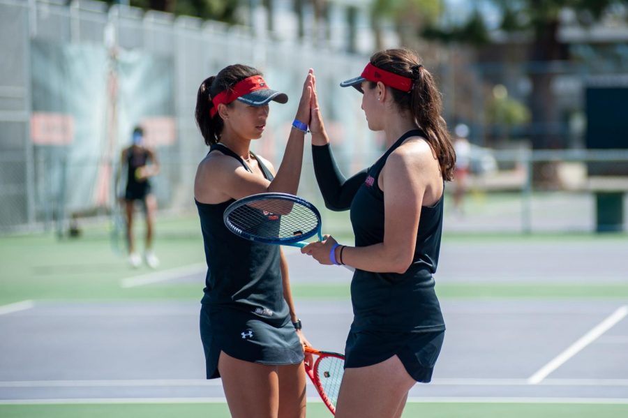 Doubles partners Jolene Coetzee, left, and Ana Toboso, right, celebrate during their doubles matchup against the Santa Clara Broncos at the Matador Tennis Complex in Northridge, Calif., on Saturday, March 27, 2021.