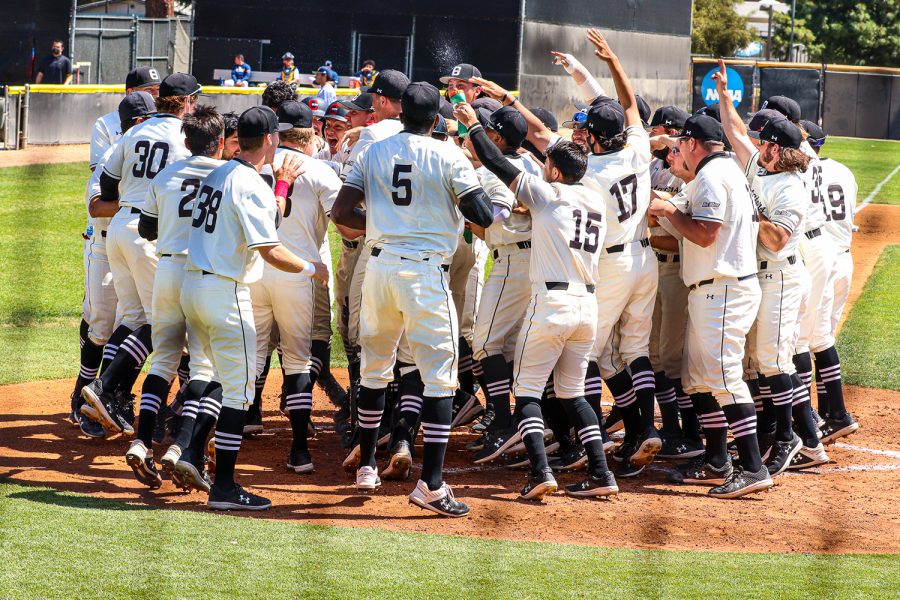 The team celebrates after Ryan Ball hits a walk-off home run to seal their win against UC Irvine at Matador Field in Northridge, Calif. on Saturday, April 3, 2021.