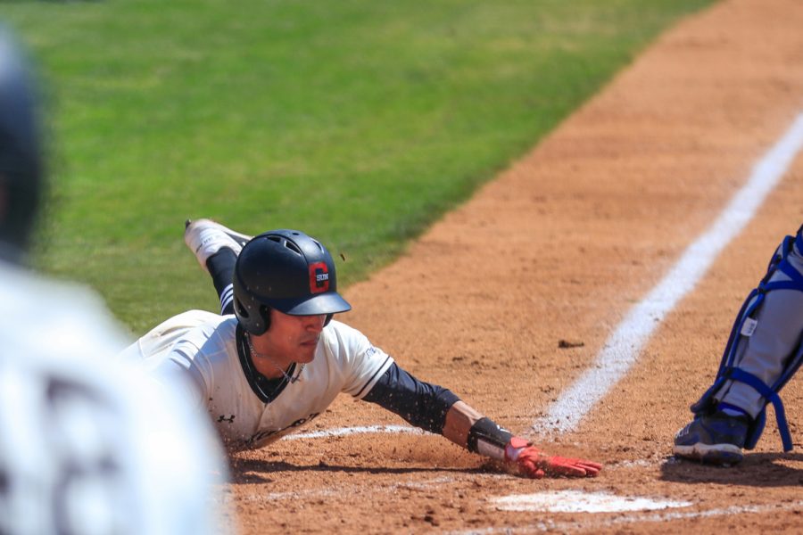 Brandon Bohning dives for home for the Matadors lone run during the first game of a doubleheader against the UC Riverside Highlanders at Matador Field in Northridge, Calif., on Saturday, April 17, 2021. The Matadors lost both games 5-1 and 8-4.