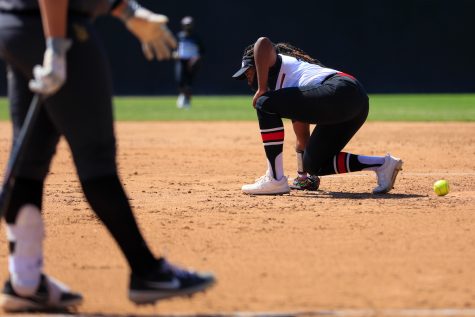 Kenedee Jamerson kneels after getting hit in the stomach during a game against Cal State Long Beach in Northridge, Calif., on Friday, April 2, 2021. The Matadors lost 9-0 in five innings.