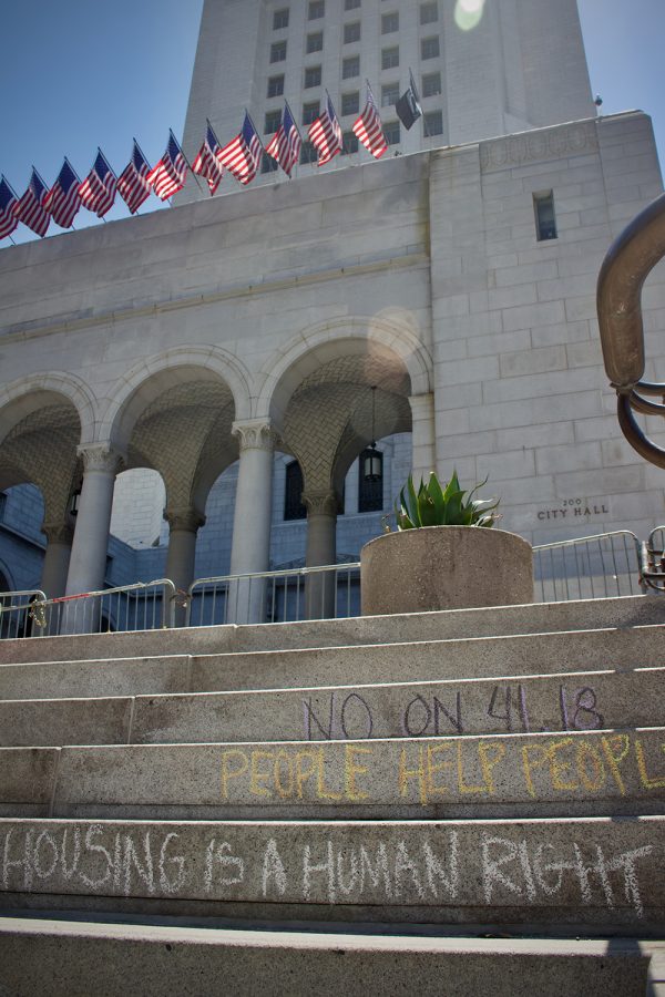 As the crowd disbursed, city hall steps were left chalked demanding a “No” vote on a proposed amendment to LA Municipal Code 41.18, which aims to criminalize individuals who sit, lie or sleep on public property within specified times and locations. City Council ultimately approved the motion, 13-2,  with Councilmembers  Nithya Raman and Mike Bonin representing the two votes against the ordinance. From Councilmen Bonin’s Twitter Statement: “….I voted against 41.18 because of that 61% of unhoused people who we cannot currently tell, when they ask us, where they can go to sleep. Until we can, pushing people around the city only makes it harder to connect with people & end homelessness by getting people housed.”
