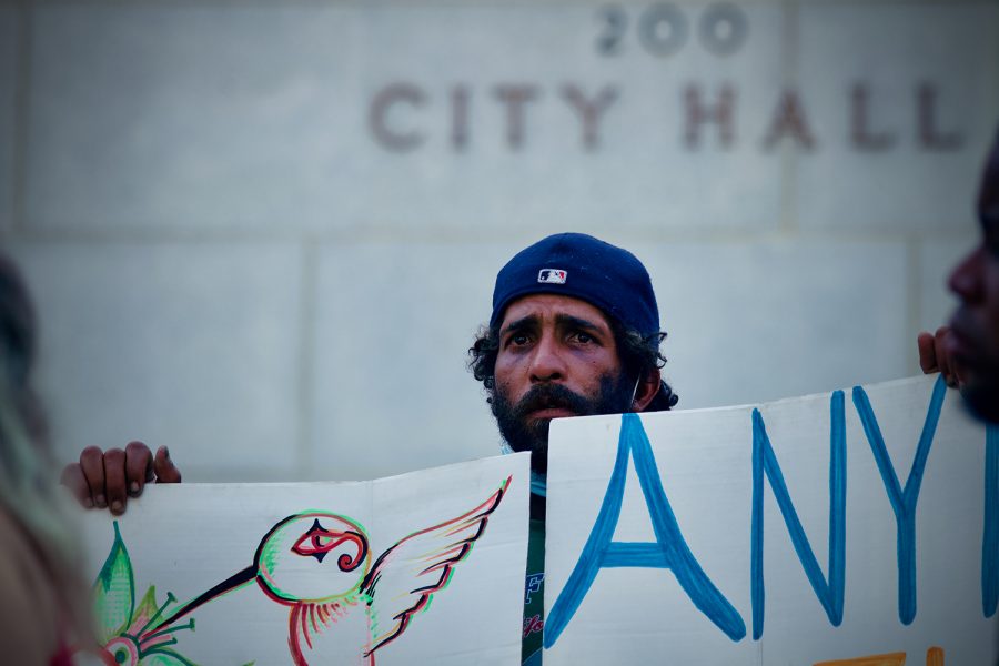 An unhoused neighbor and protester stands on the steps of Los Angeles City hall while attending a rally in opposition of a proposed motion to amend LA Municipal Code 41.18 in Downtown Los Angeles, Calif. on Wednesday, July 28 2021. As demonstrations continued LA Council Members voted in favor of the amendment, which aims to criminalize individuals who sit, lie or sleep on public property within specified times and locations; including up to 500 feet of a designated overpass, underpass, freeway ramp, tunnel or bridge.
