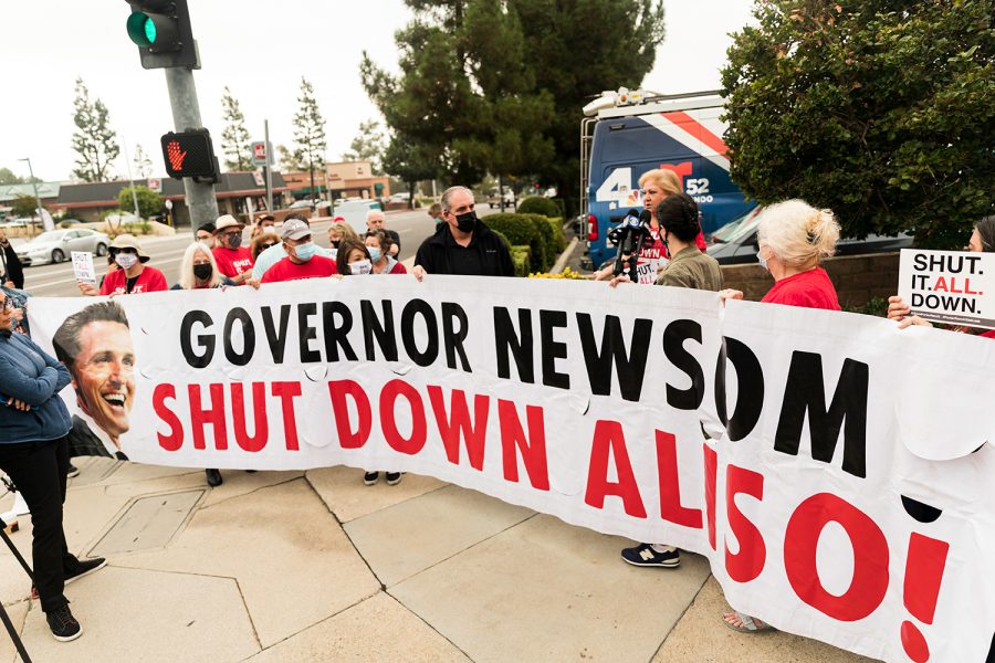 Protesters+give+comments+to+the+media+while+holding+a+banner+demanding+Gov.+Gavin+Newsom+to+shut+down+the+Aliso+Canyon+gas+storage+facility+in+Porter+Ranch%2C+Calif.%2C+on+Tuesday%2C+Sept.+28%2C+2021.