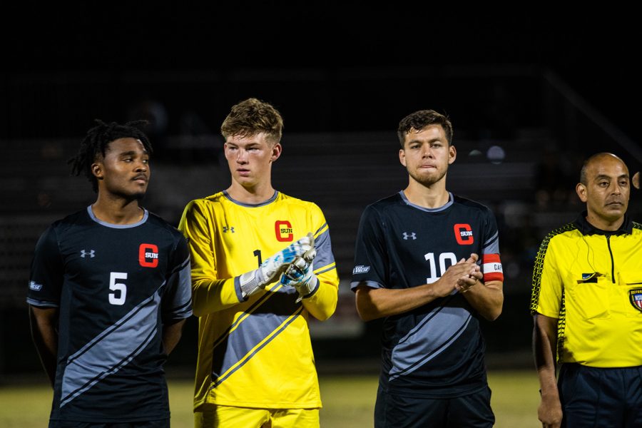 Giovanni Aguilar, extreme left, Cooper Wenzel and Omar Grey wait while the starters are announced before the game against California State University, Fullerton in Northridge, Calif. on Wednesday, Oct. 20, 2021.