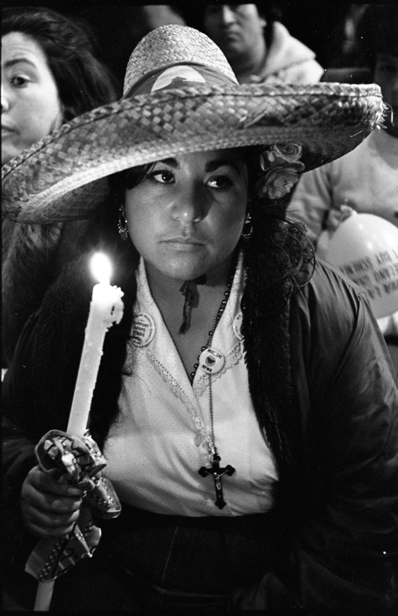 Dolores Huerta on an unidentified picket line holds a megaphone.