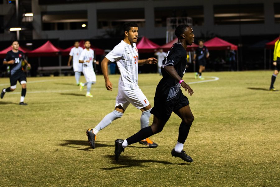 Jamar Ricketts, right, sprints after the ball during the game against California State University, Fullerton in Northridge, Calif. on Wednesday, Oct. 20, 2021.