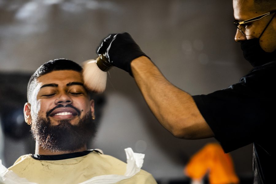 Beethoven Estupinian, left, gets a haircut from Bryan Cabrera, right, at the Standard Barbershop in Northridge, Calif., on Saturday, Oct. 9, 2021.