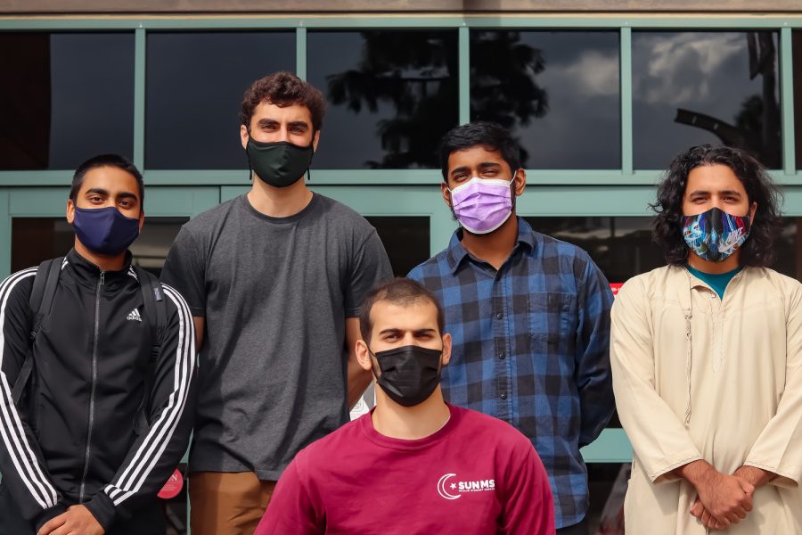 MSA President Redhawam Ahmed (extreme left) and Muslim Student Association members Zachary Gulshad, Azmi Shatela (front), Anaz Mohammed and Abdullah Tokhi stand outside of the East Conference Center at CSUN to pose for a picture.