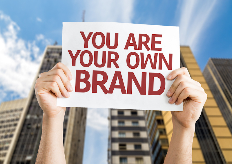 hands+holding+sign+saying+you+are+your+own+brand