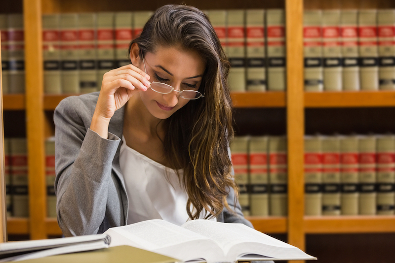 Female law student in the law library at a university