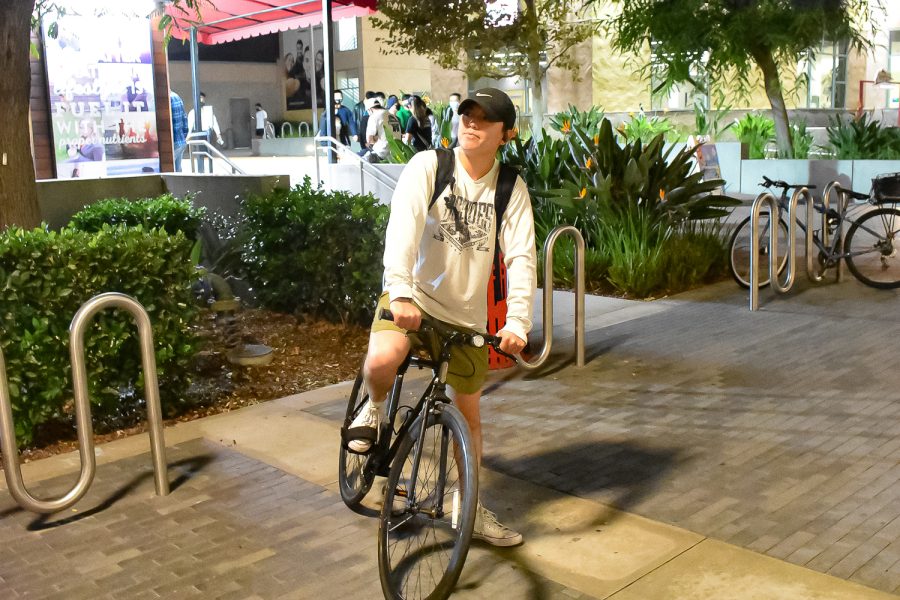 Anthony Marquez gets on his bike after working out at the Student Recreation Center at CSUN in Northridge, Calif., on Thursday, Nov. 18, 2021.