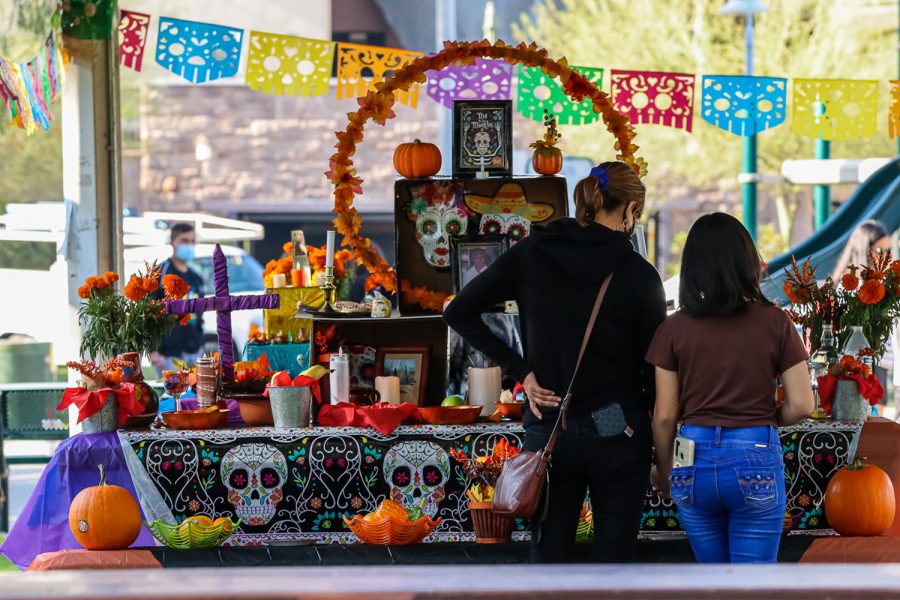 Visitors look at the ofrenda at the Día de los Muertos Cultural Festival in the San Fernando Recreation Park in San Fernando, Calif., on Saturday, Oct. 30, 2021.