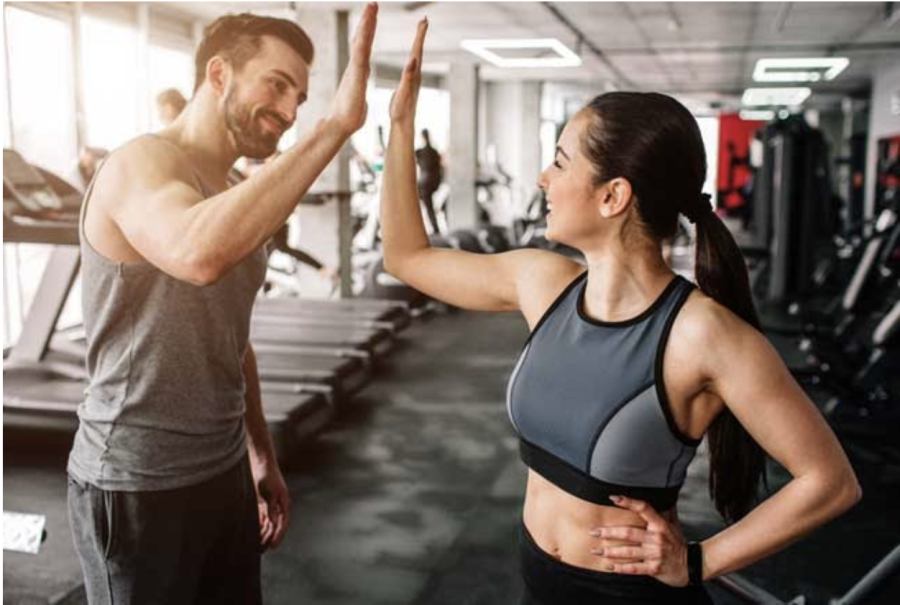 man+and+woman+high-fiving+at+gym