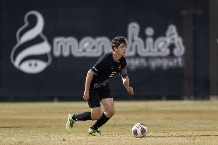 Csun mens soccer player with the ball