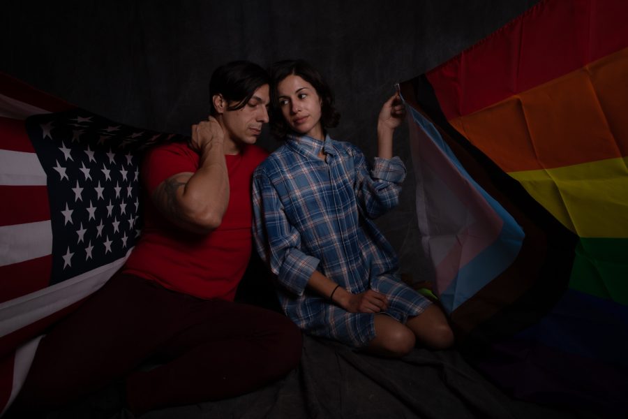 Nestor Vinelli (Left) and Ryanne Mena (right) pose for a photo illustration. Vinelli drapes the American flag across his shoulders and Mena drapes the progress pride flag across her shoulders. Photographed on Oct. 18, 2021 in Northridge, Calif.