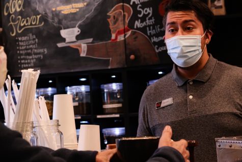 Diego Lopez, the owner of a Northridge Tea and Coffee Shop assists a customer on Oct. 18, 2021 in Northridge, Calif.