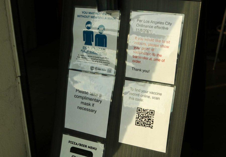 Flyers of vaccination proof requirements at the entrance of MacLeod Ale Brewing Co. on Friday, Nov. 27, 2021, in the Van Nuys neighborhood of Los Angeles, Calif.