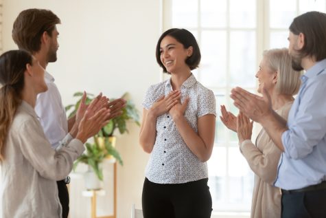 woman receiving applause from others